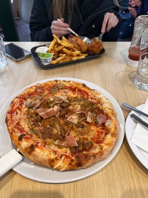Great sized and great tasting “meat feast” pizza, and their fantastic tofish and chips on the other side of the table. March 2026  at Fed By Plants in South East London