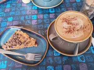 Cappuccino with oat milk and a pecan-flapjack at The Old Butchers in Lochcarron