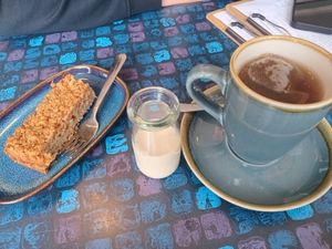 Tea with oat milk and an apple-cinnemon-flapjack at The Old Butchers in Lochcarron