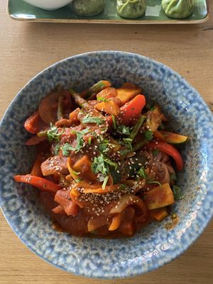 Momos with sautéed veggies in a spicy sauce  at MoMo Café in Friedrichsdorf