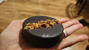 Chocolate covered shortbread with dulce de leche filling and hazelnut topping at Vegansté in Providencia