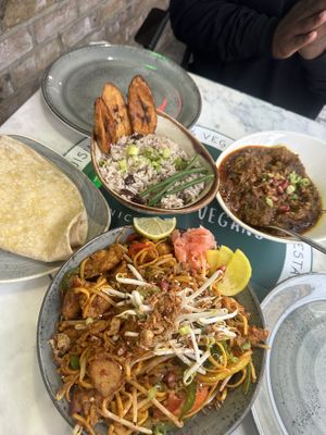 Vegan curry goat, plantain, rice and peas and roti, plus vegan chicken szechuan noodles   at Meat The Vegans in North West London
