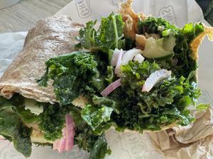 Buffalo chik’n raw-ish kale wrap with raw onions.  at Greens and Grains in Voorhees