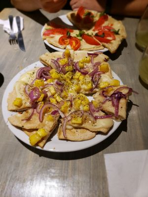 Hawaiian pizza with Napolitano pizza in the background at Cuenco in Mendoza