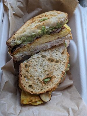 Breakfast sandwich vegan style. Egg, mushrooms, mozzarella, and avocado on sourdough. Delicious. at Roots Gastrohub in Grand Junction