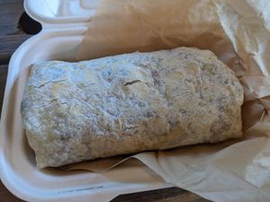 Big burrito with egg substitute, vegan sausage, vegan cheese, mushrooms, potatoes, avocado, and arugula. Delicious. at Roots Gastrohub in Grand Junction