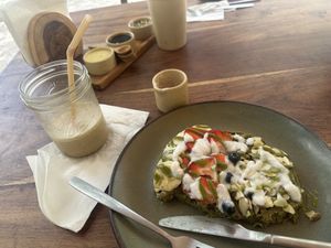 Half eaten matcha waffle and spiced coffeee  at Fresco Hábito in Cancun