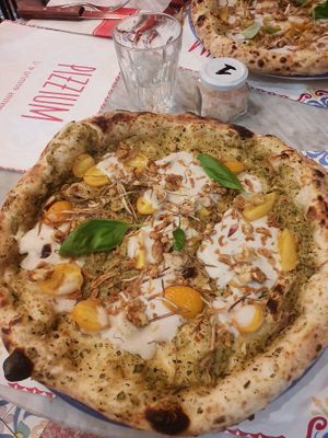 Vegan pizza with pomodori fried onion carciofi Zucchini cream vegan mozzarella at Pizzium in La Spezia