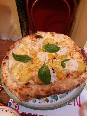 Vegan pizza with vegan mozzarella, potatoes,  pomodori at Pizzium in La Spezia