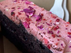 Chocolate truffle cake with raspberry rose and champagne icing   at Prism Coffee in Gateshead