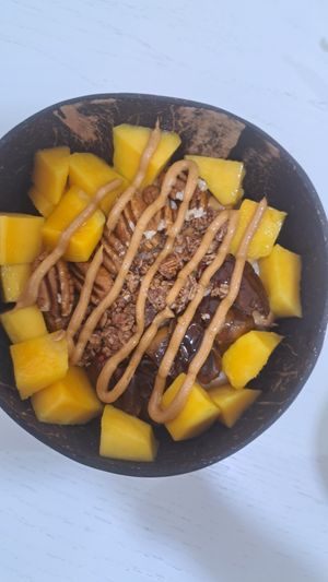 Oatmeal with mango and dates at Organic Coco Bowls  in Muscat
