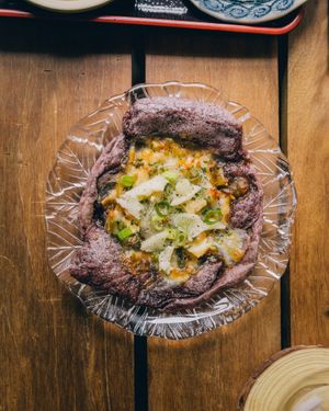 Lanna pizza using black sticky rice dough  at POHSOP in Chiang Mai