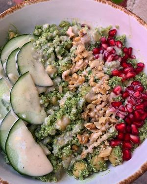 Ensalada verde, blanca y roja de quinoa en salsa “green goddess” de hoja santa y perejil, con garbanzos, granada, pepino y nuez de castilla, aderezo de nuez de castilla  at Nanita in Oaxaca