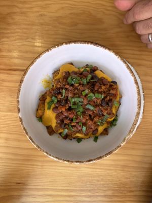 Fully loaded potatoes with red bean chili  at Nanita in Oaxaca