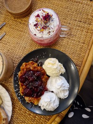 Berry waffles and pink rose latte. at Canterbury Tails Cat Cafe in Canterbury