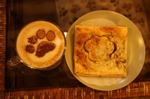 chai latte, and "cheese" and "bacon" pastry paw puff at Canterbury Tails Cat Cafe in Canterbury