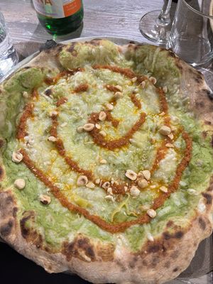 Pizza con mozzarella vegana, crema di friarielli, crema di pomodorini secchi e granella di nocciole.  at Giovanni Santarpia in Florence