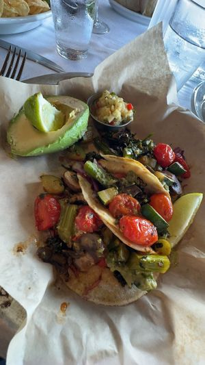 Vegan tacos! Broccolini, mushroom, tomato, and cabbage in corn tortillas with a side of avocado and pineapple pico. 10/10.  at The Boathouse in Lake Buena Vista