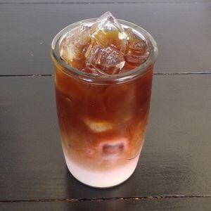 Raspberry Cream Iced Latte with Oat Milk at C.A.T. Cafe Bakery in Huntsville