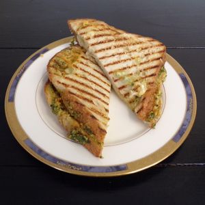 Hummus Pesto Panini: Toasted sourdough sandwich with classic hummus,  vegan pesto, fried garlic, feta, & muenster cheese. 

Vegetarian only. Can not be custom made without cheese at C.A.T. Cafe Bakery in Huntsville