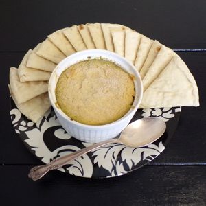 Hummus Pesto Veggie Dip (Vegan)
Layered dip made with classic hummus, vegan house pesto, oven roasted veggie blend, fried garlic, & capers. Served with optional side of pita bread at C.A.T. Cafe Bakery in Huntsville