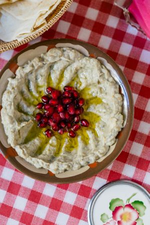 Mtabbal - thick paste made of smoked eggpland with a lot of tahina. Served with pomegranate and olive oil. at Suwayda Streetfood in Krakow