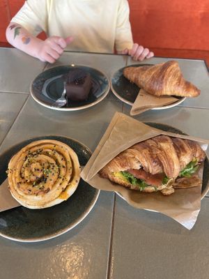 Top left: Oreo cake, top right: plain croissant, bottom left: pastry with smoked tofu, bottom right: croissant sandwich   at Nihe in Tallinn