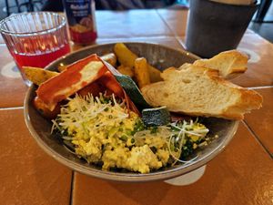 Breakfast bowl with tofu scramble, "bacon," and potato wedges at Nihe in Tallinn