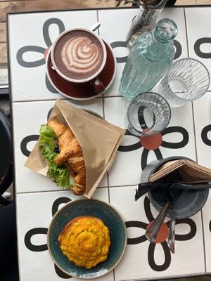 Raw cacao, „salmon“ croissant and cheese roll. at Nihe in Tallinn