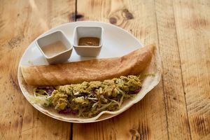 Masala Dosa

Thin & crisp crepe made from a fermented batter of black lentils and rice, comes with peanut, ginger chutney and Masala potato filling. (GF) at SAI100 in Glasgow
