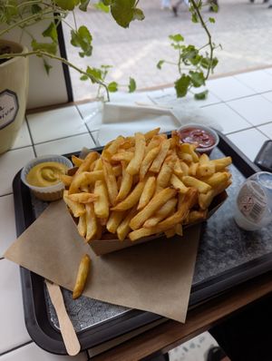Large fries with mustard and ketchup. at 't Brugsch Friethuys in Bruges