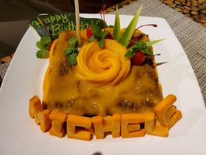 "Michele" cake made of all healthy ingredients including only organic ingredients & fruit sugars (bananas & raisins), whole oats and carrots. Topped with mango and a mango rose! at Atlantis Restaurant in Puerto Galera