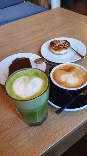 Matcha latte, cappuccino, salted caramel cake and snickers cheesecake at MiiT in Riga
