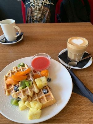 waffles with fruit and oat milk latte  at MiiT in Riga