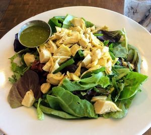 Baby Reds and Greens salad with artichoke hearts, sun-dried tomatoes and onions with basil dressing at Naked Cafe in San Diego
