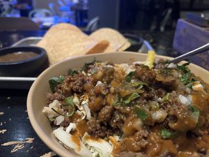 Impossible Asada Bowl, chips and salsa in the background  at Mas Taco Bar in Sacramento