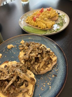Hummus & fried mushroom toast + tofu scramble (back)  at Balino Yoga Café  in Sevilla