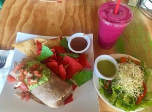 Black Bean and Brown Rice Burrito, Pitaya Smoothie. 10/10 would recommend that smoothie. Burrito needs some peppers and onions inside. Was a good size/very filling though! at Swami's Cafe in Oceanside