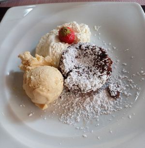 Vegan lava cake with vanilla ice cream and whipped cream at Lieblingscafé Königslutter in Konigslutter Am Elm