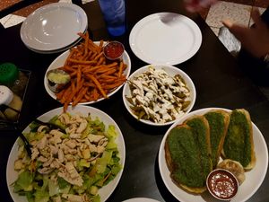 salad, sweet potato fries, garlic bread and beans at Slice of Vegas Pizza in Las Vegas