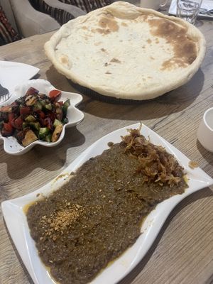 Freshly baked pita, fattoush salad and a roasted eggplant dip with crispy fried onions   at Bonu Resturan in Dushanbe