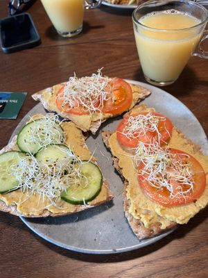 Hummus and vegan crackers with cress and fresh tomatoes and cucumber for breakfast at Blique by Nobis in Stockholm