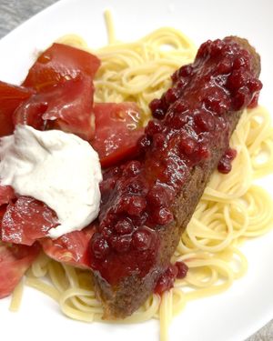 Vegan sausage with lingonberry sauce. Delivered as a semi-finished product, I fried it and served with spaghetti, fresh tomato and homemade cashew sauce. at Aygi in Yerevan