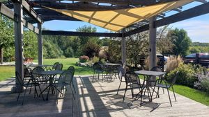Lovely outdoor seating area with rolling hills in the background. September 2024. at Cafe Wren in Luck