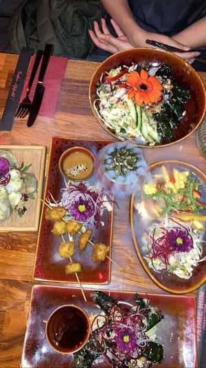 Chicken skewers, betel leaves filled with tofu, summer rolls, mango salad   at Padme Hum  in Munich