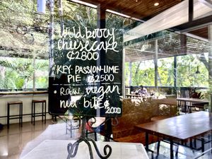 Raw vegan nut bites listed on the chalkboard on this small refrigerator   at Cafe Social in Puntarenas