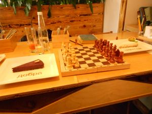 games available, chess game, with coconut dessert and blueberry dessert (vegan) at Cafe Ukrop in St Petersburg