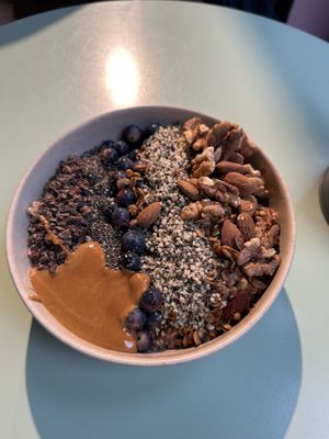 Oatmeal bowl with cacao, chia seeds, hemp seeds, blueberries, und Walnüsse    at Lucy's The Deli in Berlin