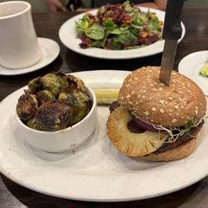brussels sprouts, buddha’s karma burger. harvest salad in back  at The Chicago Diner - Logan Square in Chicago