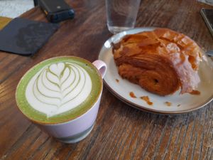 Matcha oat latte and pain au chocolat at Sloth Coffee Co in Swansea